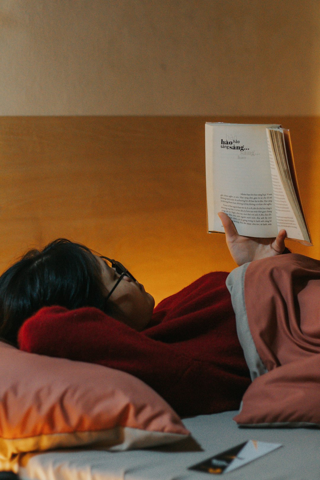 unsplash person reading a book in bed with a relaxing atmosphere viauwjw6qwq