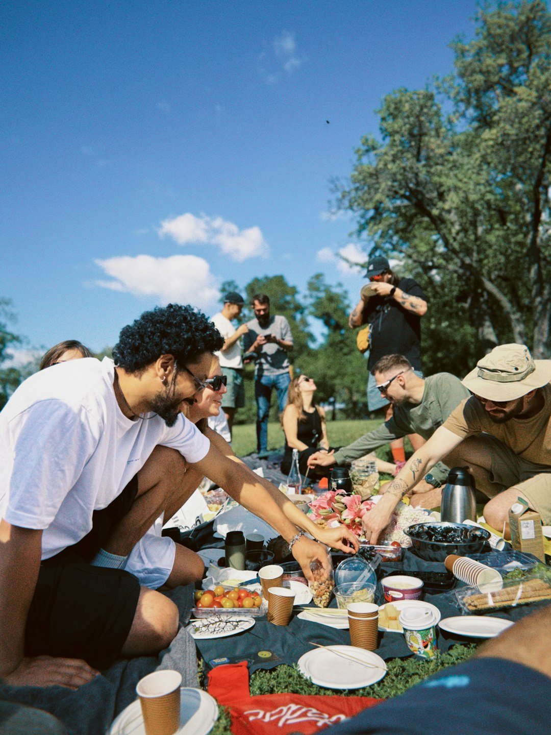 unsplash family having a picnic in a park laughing and smiling 9jpeuyoinma