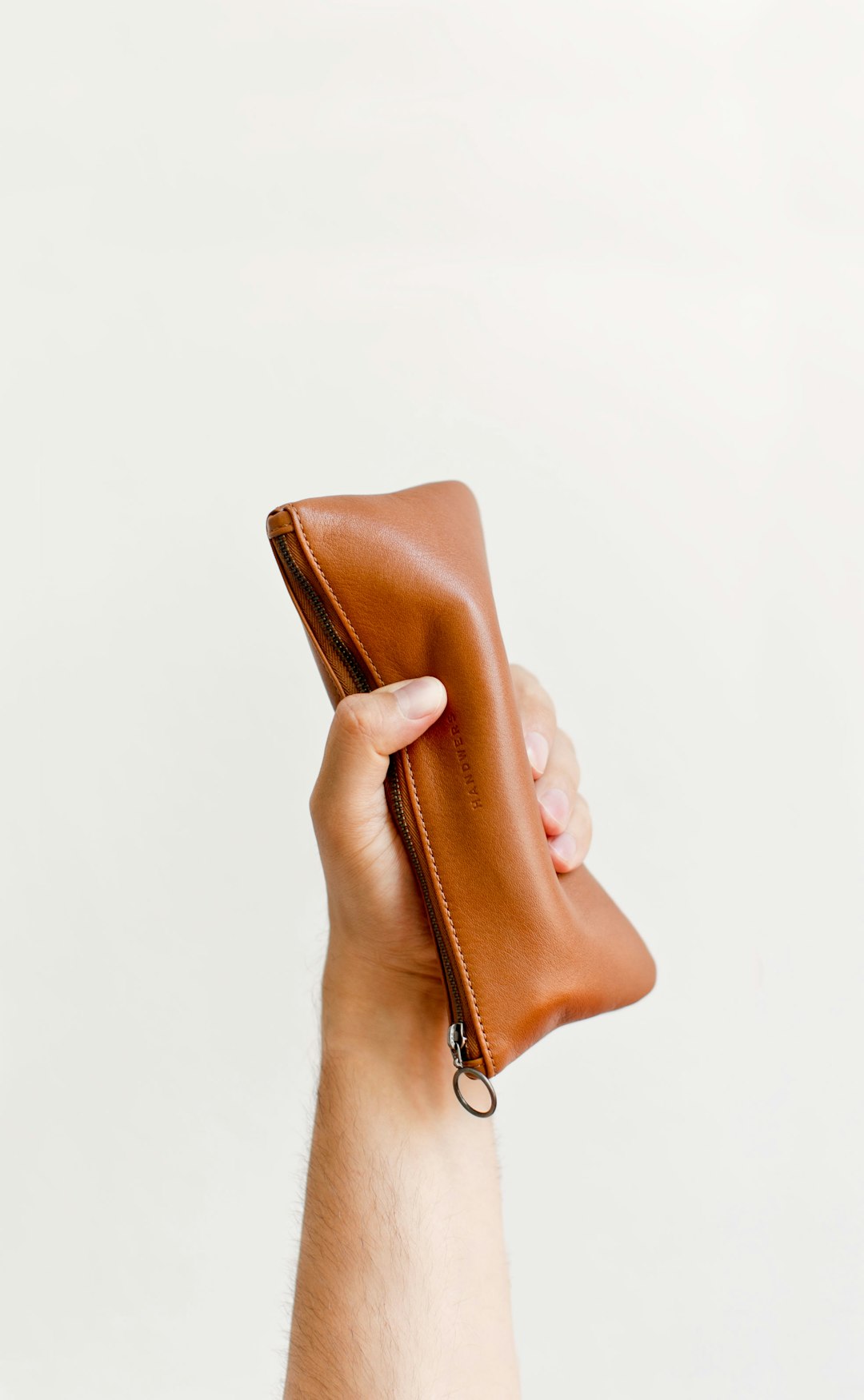 unsplash person holding a wallet and looking at a budget spreadsheet wsrpj pknae 1