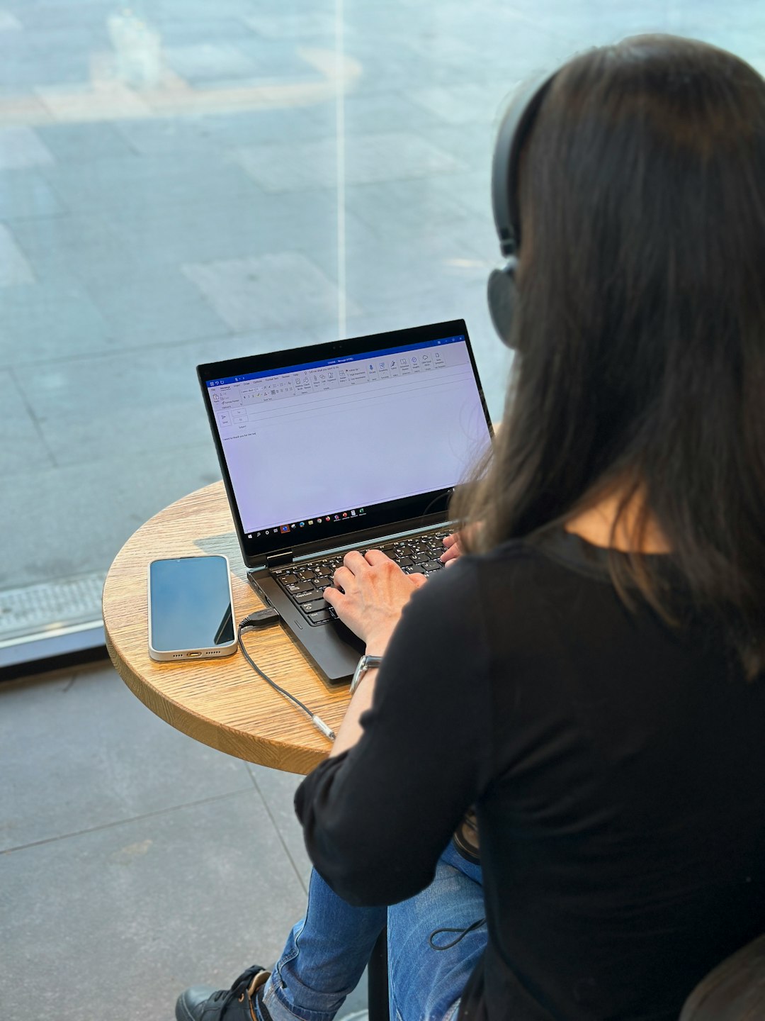 unsplash person sitting at a desk with a laptop and a notebook looking focused bmmpzbzwywg
